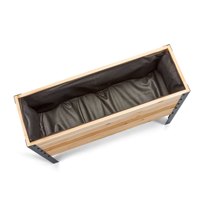 Wooden planter box with brown liner on a white background